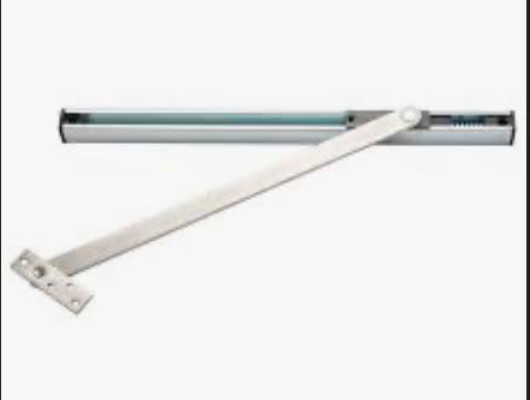 Concealed overhead stop mechanism with silver metal arm and internal spring mechanism.