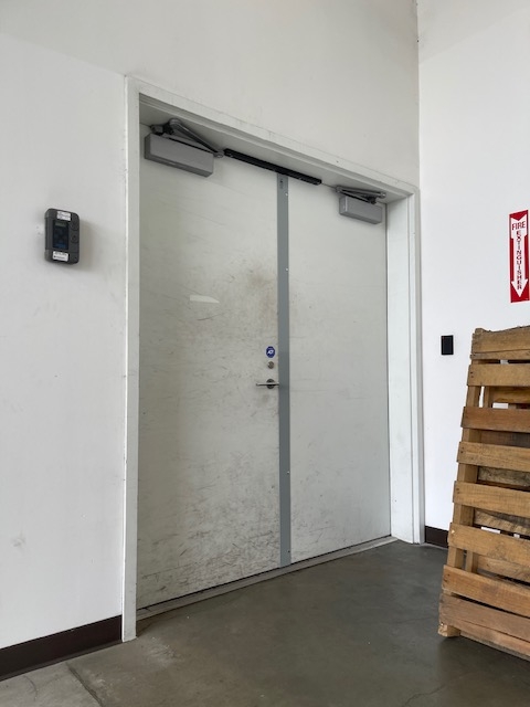Double door secured with a properly installed steel door astragal