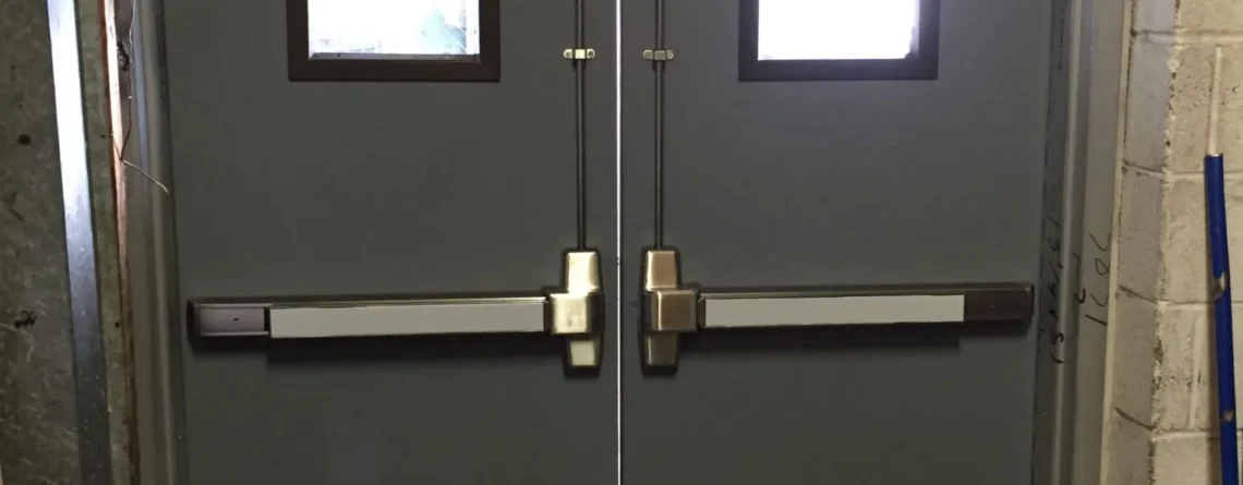 Fire-rated steel door with certification label in a commercial building corridor