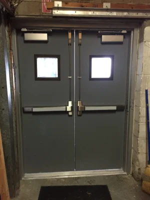 Fire-rated steel door with certification label in a commercial building corridor