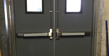 Fire-rated steel door with certification label in a commercial building corridor