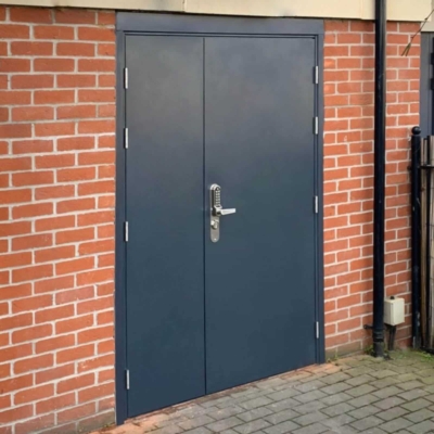 Solid steel security door installed in an industrial facility with heavy-duty locking system