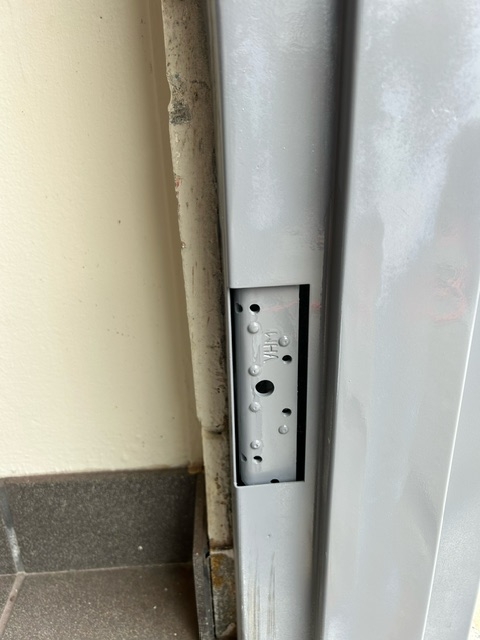 Hollow metal frame showing hardware cutout and poor alignment