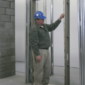 Technician inspecting a hollow metal door frame during commercial door installation in Vancouver.