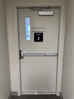 Commercial stairwell door with panic bar and door closer