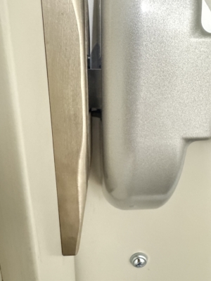 Close-up of commercial door edge and hardware alignment